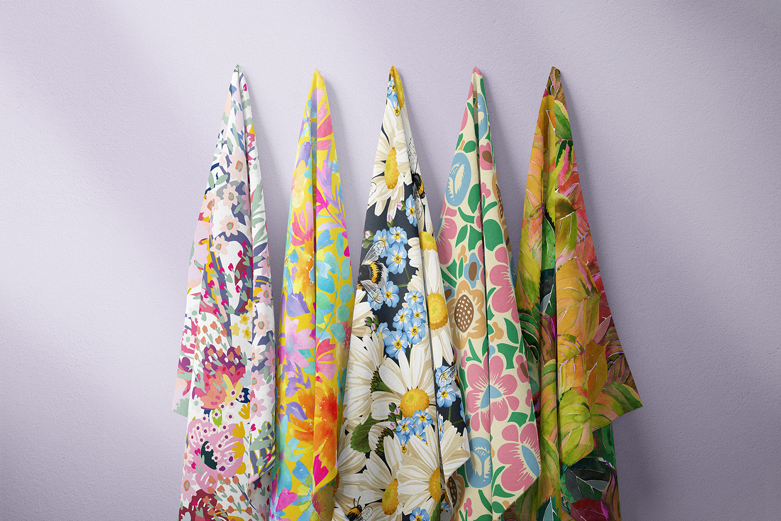 Five colorful floral custom fabric print designs hanging side by side