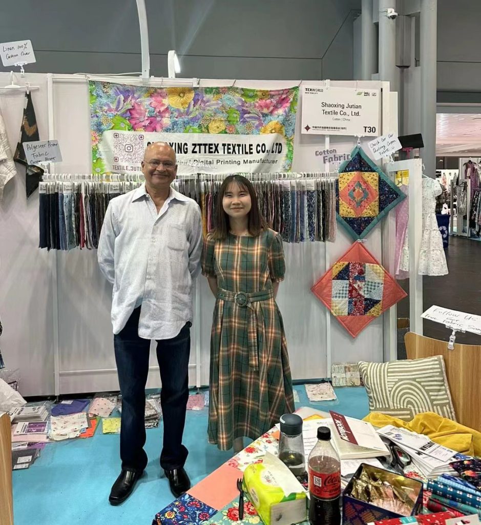 FabricsMaker team at the Texworld New York trade show booth with custom fabric samples
